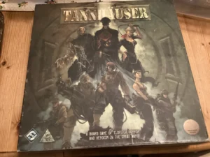 A board game named "Tannhauser" with artwork depicting various characters in a style suggesting eldritch horror and heroism during the Great War.