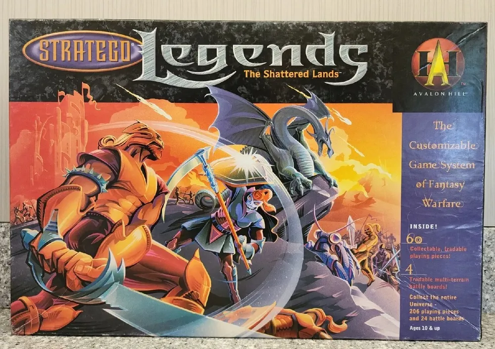 Box cover for the "Stratego Legends: The Shattered Lands" board game by Avalon Hill, featuring vibrant fantasy artwork with warrior and dragon figures, and text detailing the customizable game system with 60 collectible, tradable playing pieces for fantasy warfare.