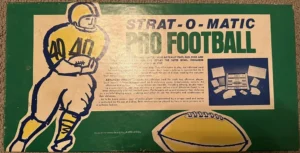 Vintage "Strat-O-Matic Pro Football" board game cover featuring an illustrated football player in a yellow and blue uniform, game title in bold lettering, along with a brief description of the game and images of game components on a green background.