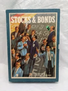 Vintage "Stocks & Bonds" board game box showing illustrated businessmen in suits and numerical figures in the background, indicating stock market activity.