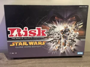 Box of the "Risk: Star Wars Clone Wars Edition" board game with illustrations of clone troopers on the cover, indicating it is for ages 10 to adult, and by Parker Brothers.