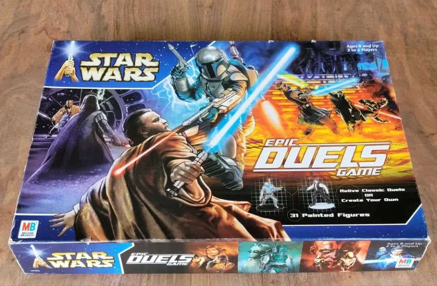 The image shows a boxed board game titled "Star Wars: Epic Duels Game" by Milton Bradley (MB) on a wooden surface. The box art features illustrations of iconic characters from the Star Wars franchise engaged in lightsaber battles, with a tagline "Relive Classic Duels or Create Your Own" and a note that the game includes 31 painted figures. The game is designed for ages 8 and up and for 2 to 6 players.