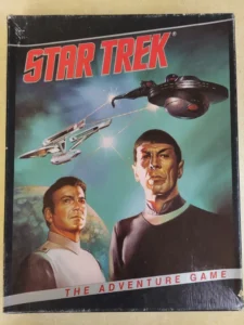 A vintage Star Trek board game cover featuring illustrations of two characters in uniform, a spaceship battle in space, and the text "STAR TREK THE ADVENTURE GAME."