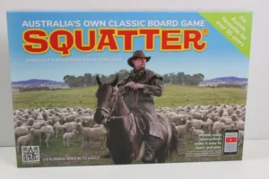 Box of "SQUATTER Australia's Own Classic Board Game" featuring an image of a man on horseback herding sheep, with text stating "Over half a million sold in Australasia" and "2-6 players, ages 10 to adult." A QR code is present in the bottom left corner, and a note about mobile video instructions is on the bottom right.