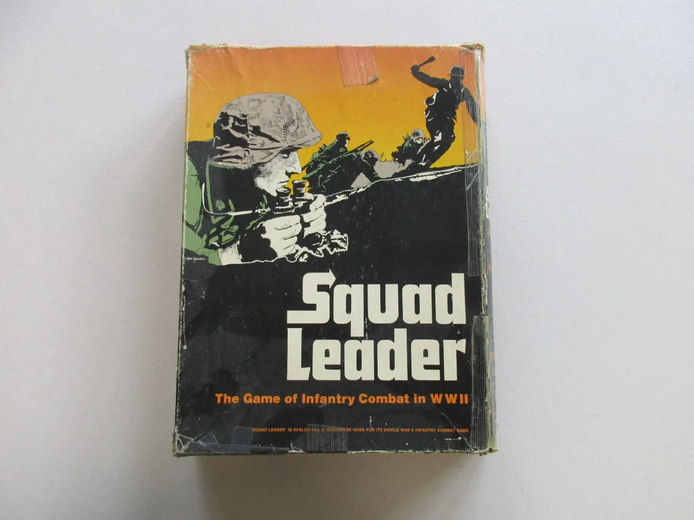 A worn-out board game box for "Squad Leader, The Game of Infantry Combat in WWII," featuring stylized illustrations of soldiers in combat.