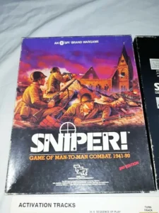 Box cover of "SNIPER! GAME OF MAN-TO-MAN COMBAT, 1941-90 2nd Edition," an SPI brand wargame, featuring artwork of soldiers in combat with a burning church in the background.
