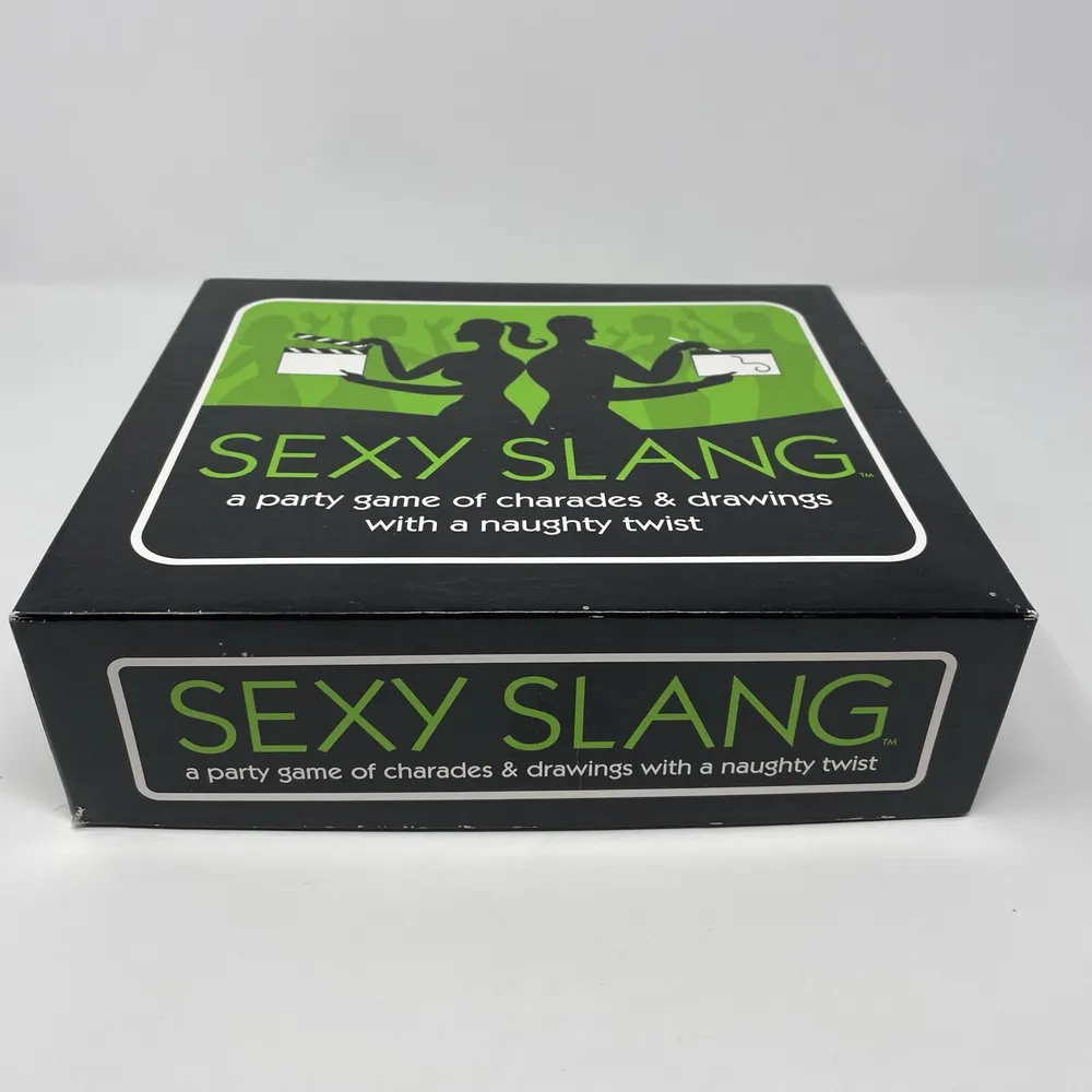 A game box for "SEXY SLANG," described as a party game of charades & drawings with a naughty twist. The box is black with green accents and white text, featuring silhouetted figures on the lid.