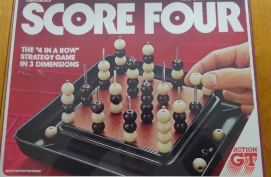 The image displays the "Score Four" board game box by Lakeside, highlighting the 3D strategy gameplay with black and beige beads on vertical posts, and a person's hand placing a bead on the game board.