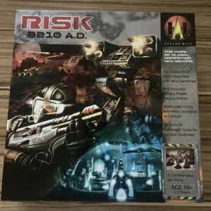 Board game box cover for "RISK 2210 A.D." featuring futuristic soldiers, robots, and spacecraft with text highlighting game features, set on a wooden background.