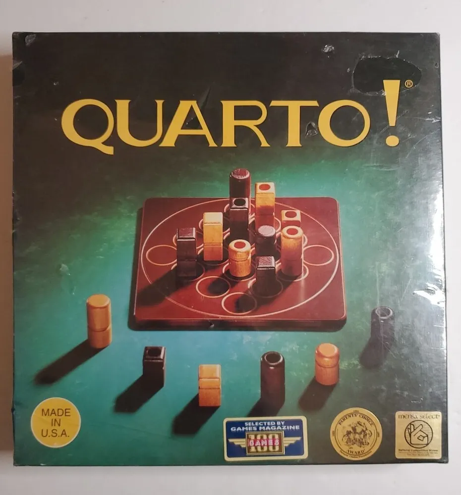 The image shows the box cover of the board game “QUARTO!” with various cylindrical wooden pieces of different heights and features displayed on a 4x4 grid board. The box has a green and black background and includes badges stating "MADE IN U.S.A.," "SELECTED BY GAMES MAGAZINE," and "MENSA SELECT."