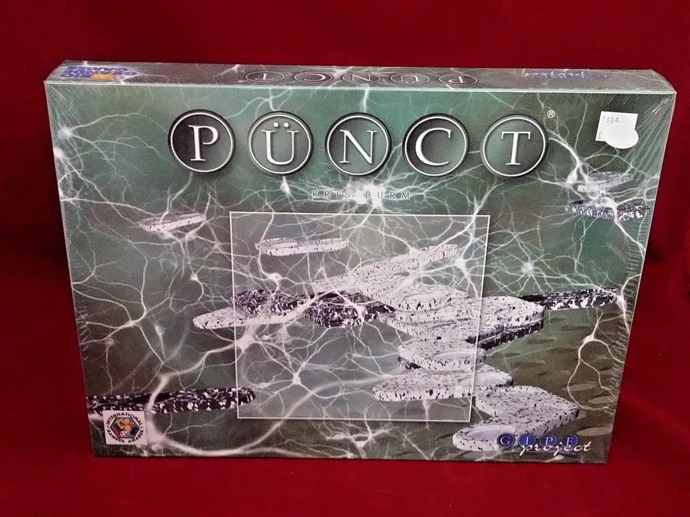 A sealed game box of "PÜNCT" displayed on a red background, with a price sticker in the upper right corner.