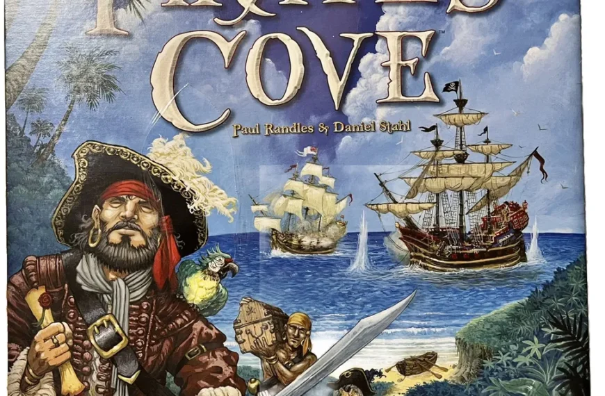 Board game cover titled "Pirate's Cove" with illustrations of a pirate with a sword, a parrot, ships at sea, and the names Paul Randles & Daniel Stahl, published by Days of Wonder.