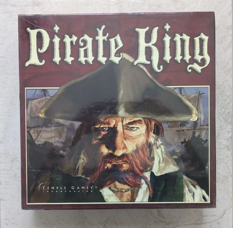 Alt text: A box cover of the board game "Pirate King" by Temple Games, featuring an illustration of a pirate with a tricorn hat and ships in the background.