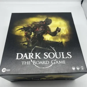 A "DARK SOULS THE BOARD GAME" box with a graphic of a menacing armored figure on the cover, produced by Steamforged Games, for 1-4 players, ages 14 and up.