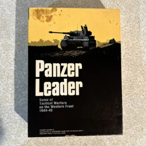 Alt text: The image shows the cover of a board game titled "Panzer Leader", with an illustration of a tank on a yellow and black background. The cover also reads "Game of Tactical Warfare on the Western Front 1944-45" and includes a note that Panzer Leader is Avalon Hill's trademark name for its World War II Western Front tactical game. There are visible signs of wear and a stain on the cover.