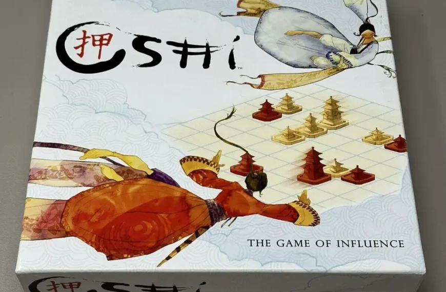 Image of a board game titled "SHŌBU" with the subtitle "THE GAME OF INFLUENCE" on the box cover, which features artistic depictions of a flying egret carrying a stone while a crawfish with a human-like posture observes a chessboard pattern with game pieces, set against a background with wave patterns.