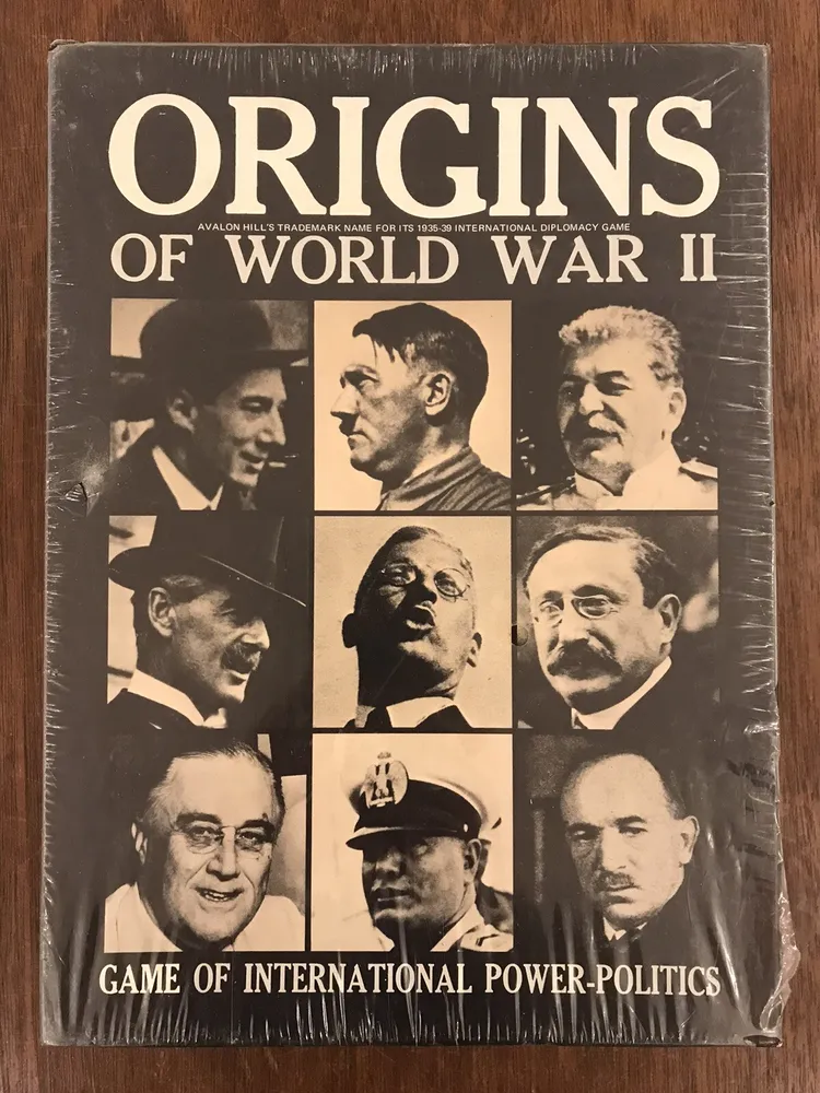 Alt text: The image shows a board game cover titled "ORIGINS of WORLD WAR II" with monochrome photographs of historical figures, and the text "Avalon Hill's trademark name for its 1935-39 international diplomacy game" and "GAME OF INTERNATIONAL POWER-POLITICS" at the bottom. The game appears to be wrapped in plastic.