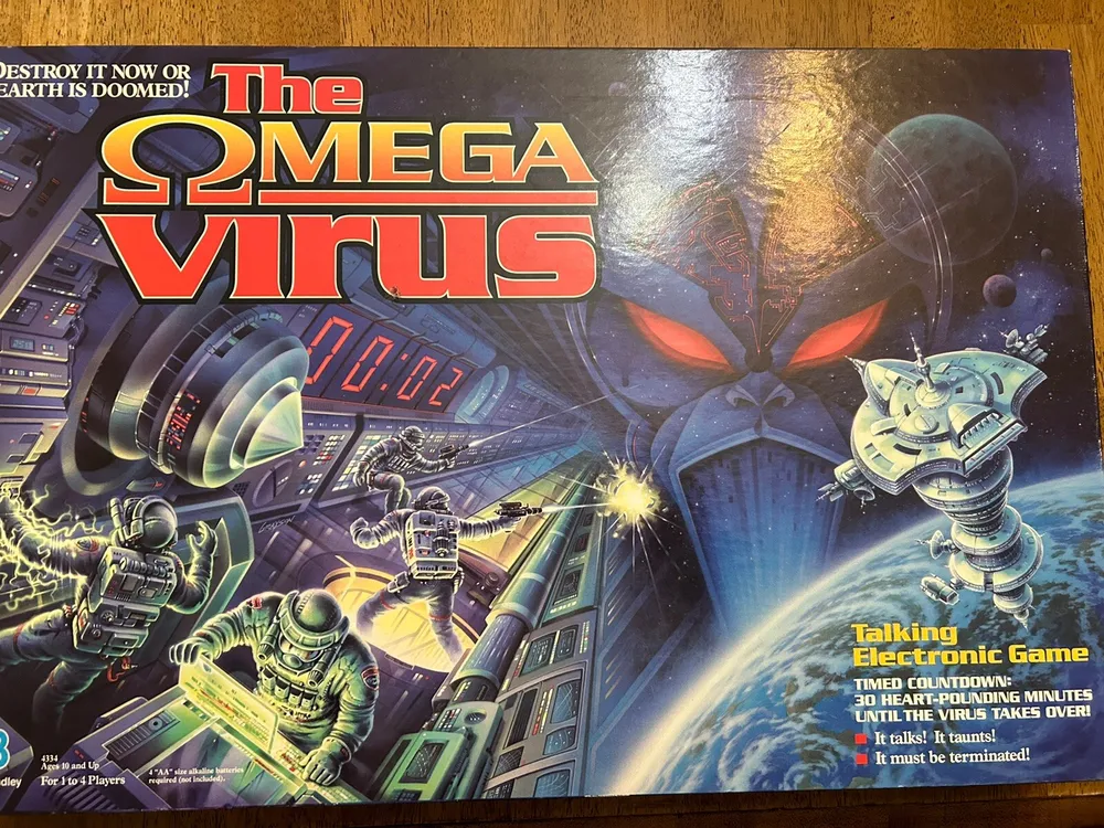 "The Omega Virus" board game box art featuring futuristic space setting with armed astronauts, a large virus-like entity in the background, and a space station; includes texts like "Destroy it now or the Earth is doomed!" and "Talking Electronic Game".