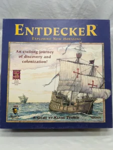 Board game box titled "Entdecker Exploring New Horizons" featuring an illustrated galleon sailing on the ocean, with the text "An exciting journey of discovery and colonization!" and logos for Mayfair Games, Kosmos, and a Spiel des Jahres Winner award.