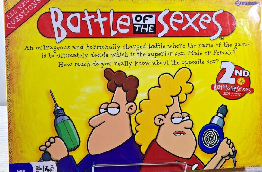 A colorful board game box titled "Battle of the Sexes" with cartoon illustrations of a man and a woman holding oversized props—a power drill and a hair dryer—having a fierce expression, indicating a humorous competition between genders. The box notes it's the "2ND Battle of the Sexes EDITION" and is intended for players aged 12 and up.