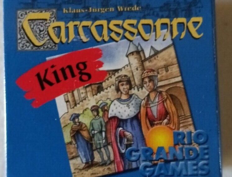 A close-up of the "Carcassonne: King" board game expansion box by Klaus-Jürgen Wrede, showing medieval characters in front of a castle and the Rio Grande Games logo.