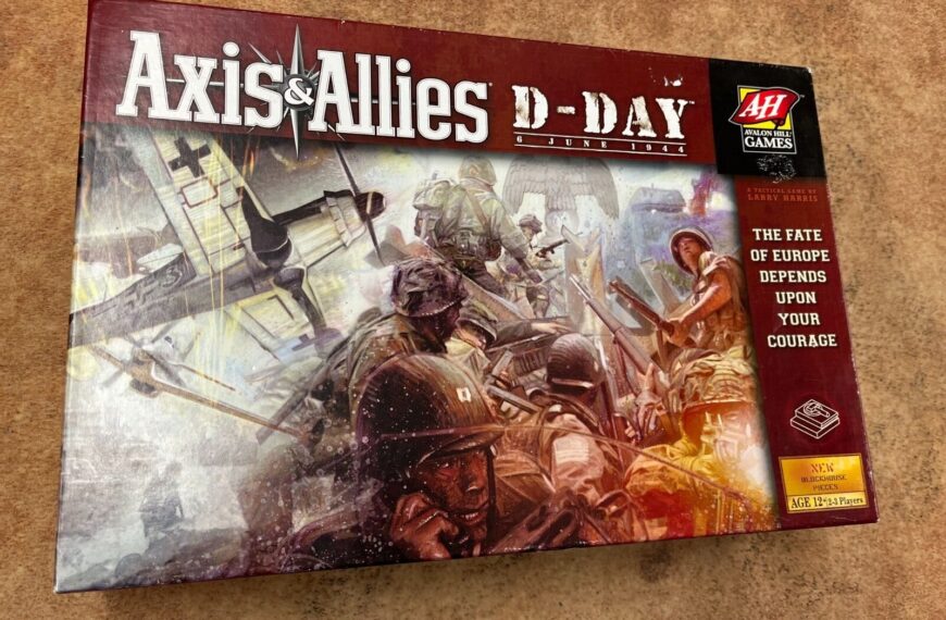 A board game named "Axis & Allies D-Day," with artwork depicting World War II soldiers in combat, positioned on a textured surface.