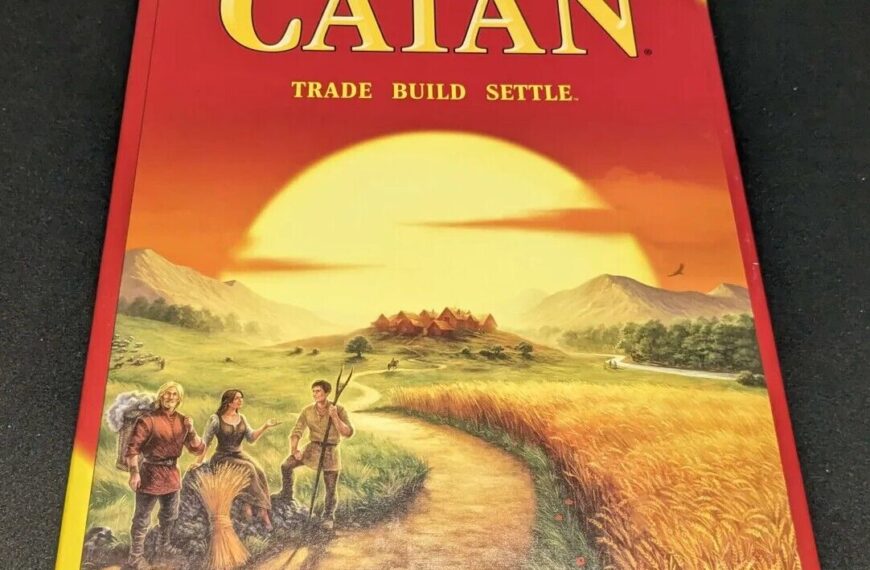 A photo of the board game "Klaus Teuber's CATAN" box with the tagline "Trade Build Settle" featuring artwork of three people on a landscape at sunset.
