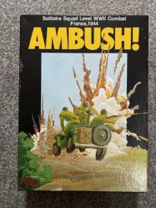 A boxed board game titled "AMBUSH! Solitaire Squad Level WWII Combat France,1944" with artwork depicting a military vehicle and soldiers in an explosion. The Victory Games logo is visible at the bottom left corner.