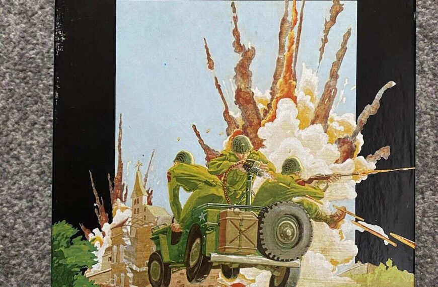 A boxed board game titled "AMBUSH! Solitaire Squad Level WWII Combat France,1944" with artwork depicting a military vehicle and soldiers in an explosion. The Victory Games logo is visible at the bottom left corner.