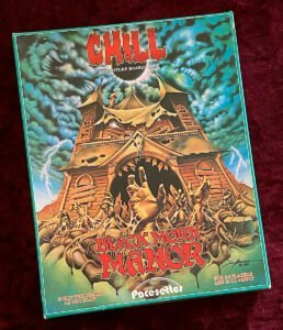 The image shows the box cover of "CHILL: Black Morn Manor," an adventure board game. The artwork features a dark, haunted manor with eerie figures and lightning in the background. The text indicates it is for 2-6 players, ages 12 to adult.