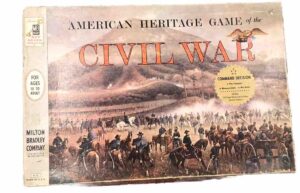A box of the "American Heritage Game of the CIVIL WAR", a board game by Milton Bradley Company, intended for ages 10 to adult, with an illustration of a Civil War battle scene featuring soldiers on horseback and infantry with a backdrop of smoke and combat.