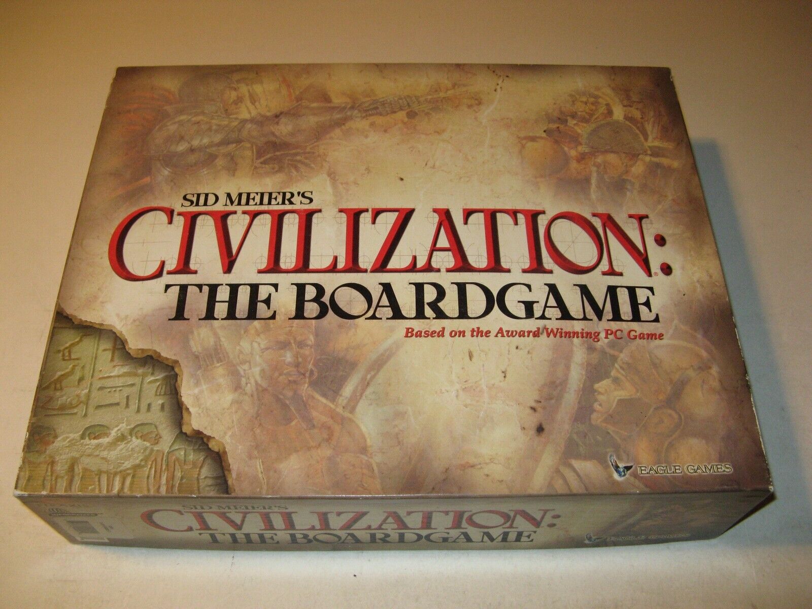 A worn-out box of "Sid Meier's Civilization: The Boardgame" with visible wear and tear on the edges, displaying the title and noting it is based on the award-winning PC game by Eagle Games.