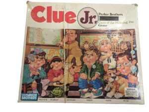 Worn board game box for "Clue Jr: Case of the Missing Pet" by Parker Brothers, featuring illustrations of six child characters with a pet and detective theme.