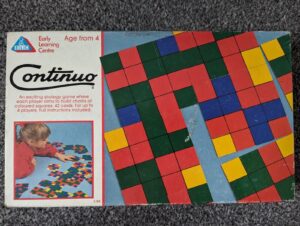 A worn game box cover for "Continuo" from the Early Learning Centre, showing colorful square patterns and a picture of a child playing the game.