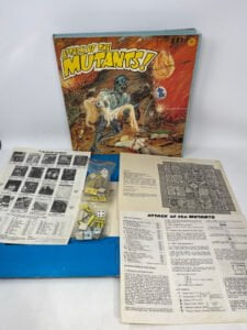 "Attack of the Mutants" board game box with artwork depicting a blue mutant, along with game pieces, dice, and instructional papers spread out on a white surface.
