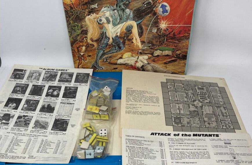 "Attack of the Mutants" board game box with artwork depicting a blue mutant, along with game pieces, dice, and instructional papers spread out on a white surface.