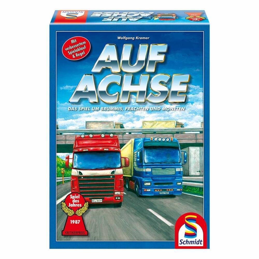 Box cover of the "Auf Achse" board game featuring illustrated red and blue trucks on a roadway with the title in bold letters, game information, and a Spiel des Jahres award badge.