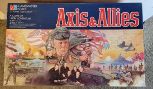 Box cover for the "Axis & Allies" board game depicting various military figures, planes, tanks, and ships from World War II, with a strategic map in the background, under the GameMaster Series logo and game information for 2-5 players, ages 12 to adult.