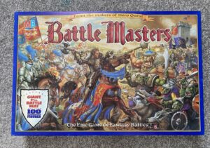 Image of a "Battle Masters" board game box with dynamic artwork featuring knights fighting against orcs and other fantasy creatures, with the subtitle "The Epic Game Of Fantasy Battles" visible at the bottom.