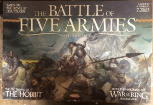 Board game cover for "The Battle of Five Armies" based on the novel "The Hobbit" by J.R.R. Tolkien, featuring a dramatic illustration of a fantasy battle with various warriors and creatures.