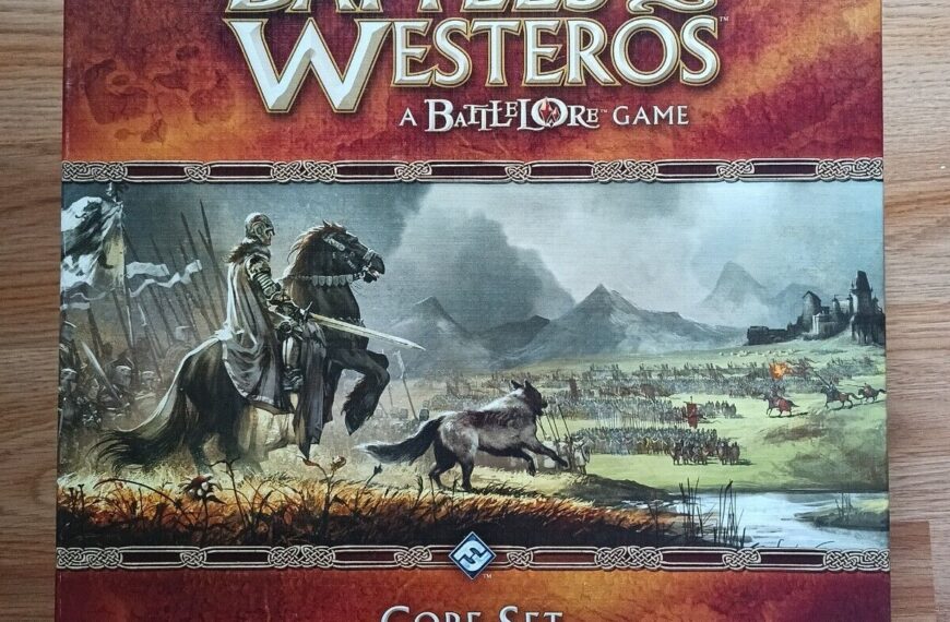 A board game named "Battles of Westeros: a Battlelore Game, Core Set" is placed on a wooden surface. The artwork on the box features medieval-style battle scenes with knights and soldiers in a fantasy landscape.