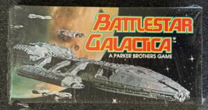 An image of a "Battlestar Galactica" board game by Parker Brothers, featuring artwork of spaceships against a space backdrop with a colorful logo above.
