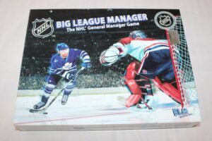 Box for "BIG LEAGUE MANAGER The NHL General Manager Game" featuring an illustrated ice hockey player in a Toronto Maple Leafs uniform taking a shot on goal against a Montreal Canadiens goalie. The NHL logo and a "Official Licensed Product" holographic sticker are visible on the box.