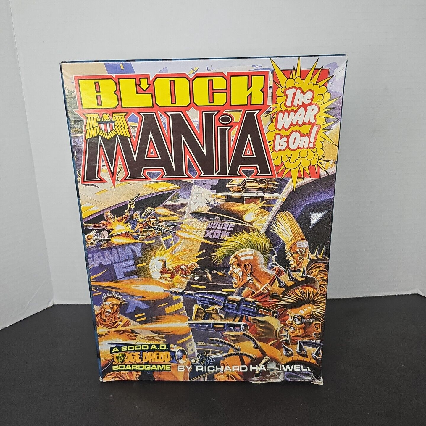 A boxed board game titled "Block Mania" with dynamic and colorful artwork depicting futuristic combat and characters, and text stating, "The WAR is On!" on the cover. The game is associated with the "2000 A.D. Judge Dredd" universe, designed by Richard Halliwell.