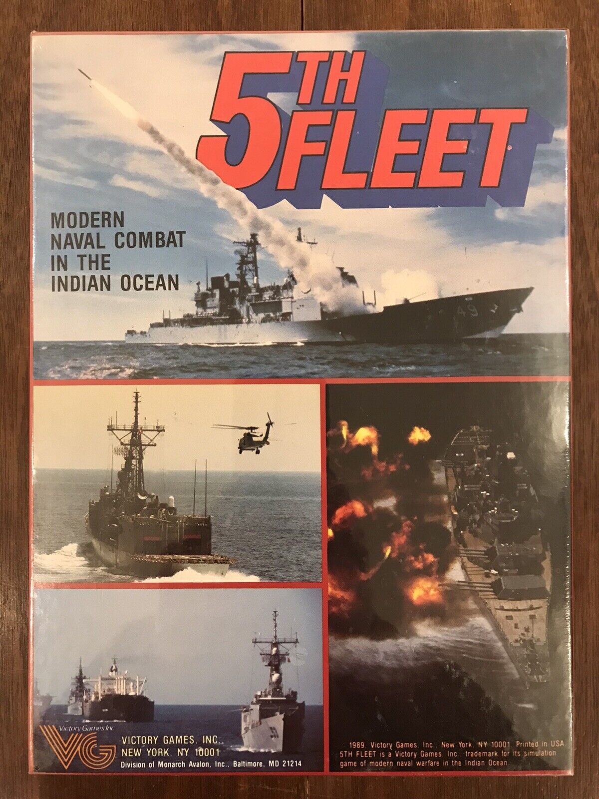 Box cover of "5th Fleet" board game, featuring images of modern naval combat in the Indian Ocean with military ships, a helicopter, and explosions at sea. Text includes the game's title, description, and publisher information (Victory Games Inc.).
