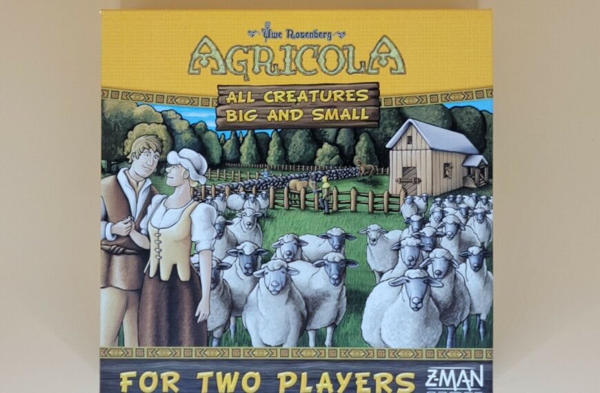 Alt text: Cover of the board game "Agricola: All Creatures Big and Small" featuring a cartoon illustration of a farm scene with a man and woman in period clothing standing in front of a flock of sheep, a barn, and fenced pastures, with the text "For Two Players" and the Z-Man Games logo at the bottom.