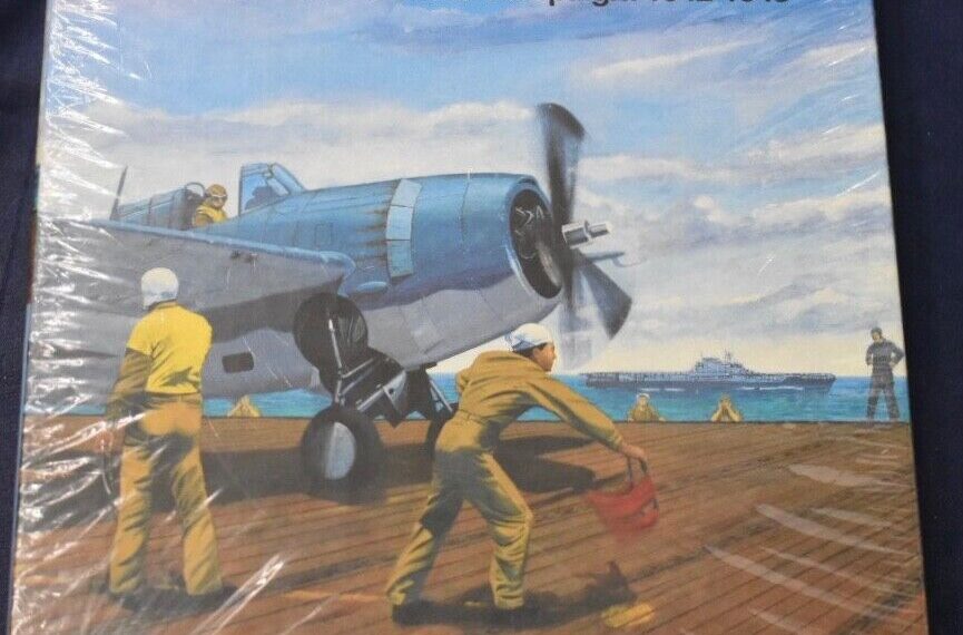 A shrink-wrapped board game titled "CARRIER The Southwest Pacific Campaign: 1942-1943" featuring an illustration of deck crew personnel in yellow attire preparing a blue military aircraft for takeoff on an aircraft carrier. The background shows a clear sky and another aircraft carrier in the distance. Visible on the cover is the publisher information "1990 Victory Games, Inc." with an address in Baltimore, Maryland, USA.