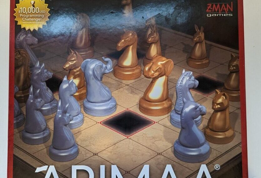 A box cover of the board game "Arimaa" featuring stylized animal chess pieces on a game board, with the Z-Man Games logo and text stating a $10,000 programming challenge.