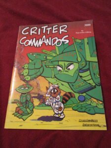 The image shows the cover of a book titled "CRITTER COMMANDOS" with colorful cartoon illustrations of anthropomorphic animal soldiers in military outfits, including a prominent frog character in a green uniform with a helmet and a raccoon character in a white space suit with a gun. The book is authored by Paul Arden Lidberg and is part of the "3000" series by Crunchy Frog Enterprises.