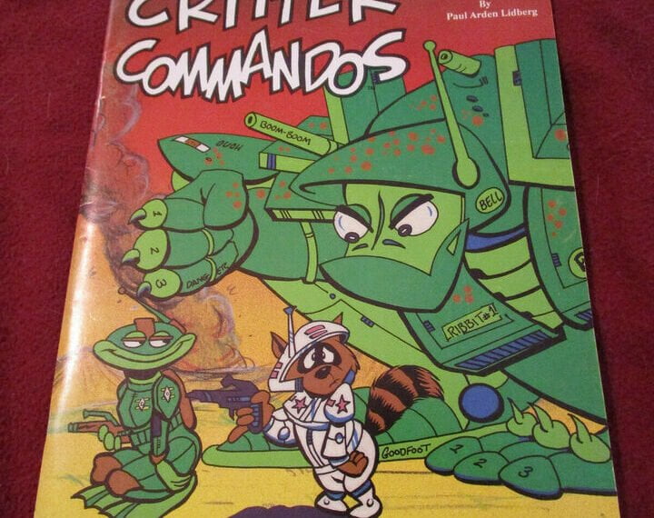 The image shows the cover of a book titled "CRITTER COMMANDOS" with colorful cartoon illustrations of anthropomorphic animal soldiers in military outfits, including a prominent frog character in a green uniform with a helmet and a raccoon character in a white space suit with a gun. The book is authored by Paul Arden Lidberg and is part of the "3000" series by Crunchy Frog Enterprises.